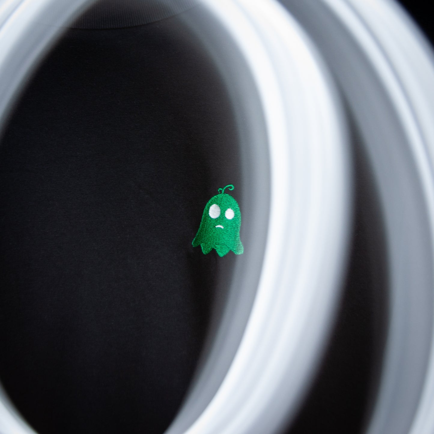 Close-up of the LONELY design with an embroidered green ghost and sharp lightning