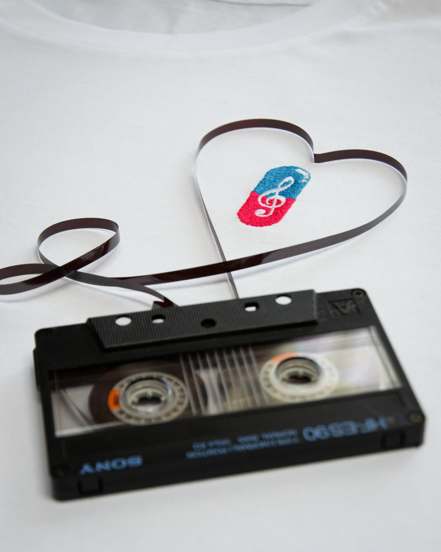 Close-up of MUSICAL REMEDY design with a music inspired cartoon surrounded by cassettes