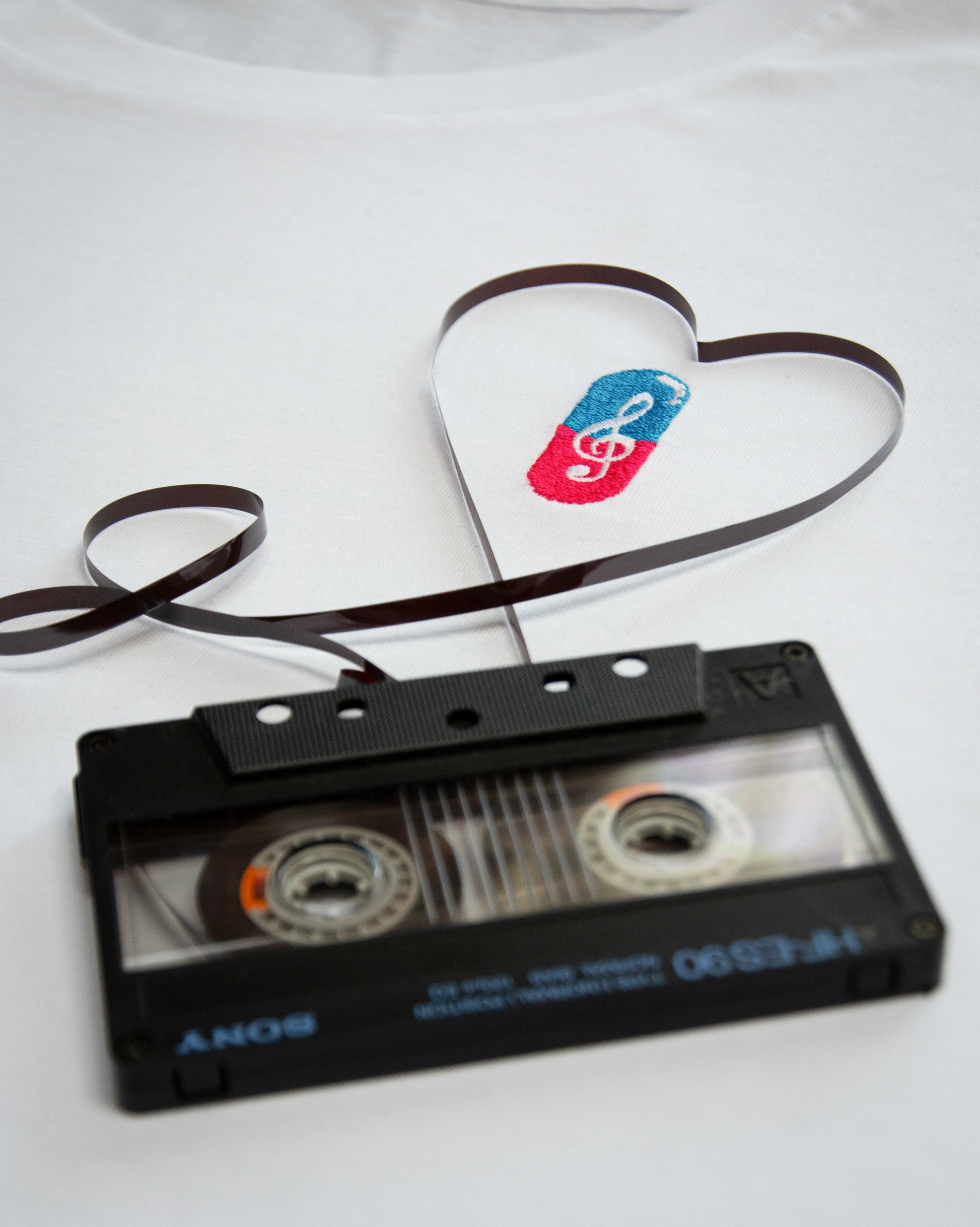 Close-up of MUSICAL REMEDY design with a music inspired cartoon surrounded by cassettes